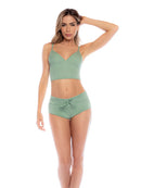 Woman wearing a green bikini set on a white background