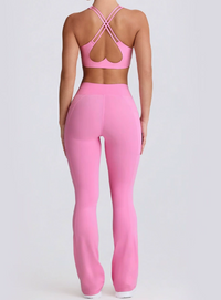 Person wearing a pink sports bra and leggings set on a light gray background