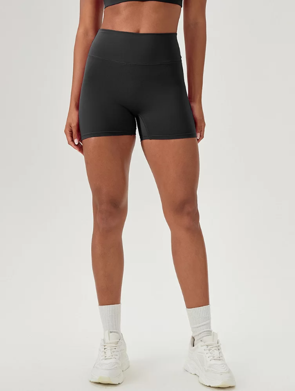 Person wearing black athletic shorts on a white background