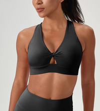 Black sports bra worn by a model on a plain background