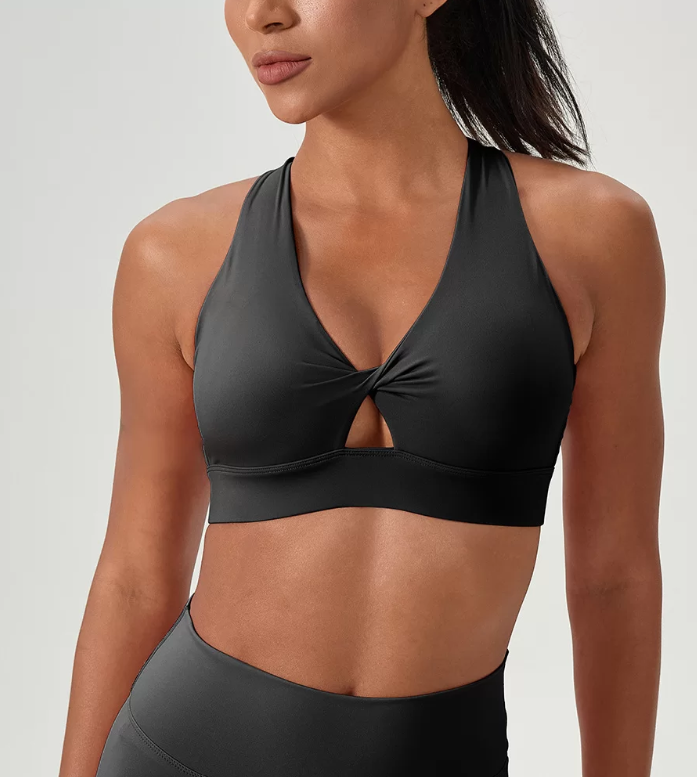 Black sports bra worn by a model on a plain background