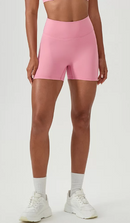 Person wearing pink shorts on a white background