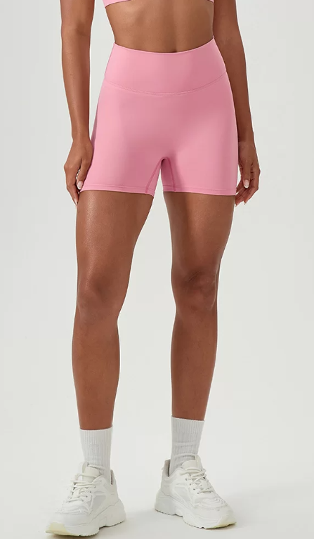Person wearing pink shorts on a white background