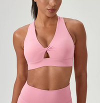 Pink sports bra and leggings on a plain background