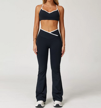 Person wearing a black sports bra and leggings set on a white background