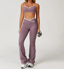 Person wearing a mauve sports bra and leggings set on a white background