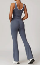 Person wearing a gray jumpsuit on a plain background