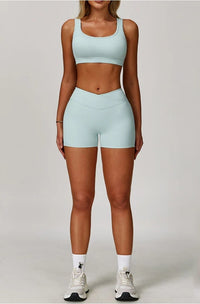 Person wearing a light blue sports bra and shorts set