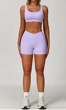 Person wearing a light purple sports bra and shorts set