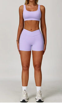 Person wearing a light purple sports bra and shorts set