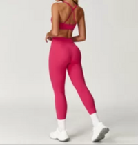 Person wearing a pink athletic outfit on a light gray background