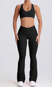 Person wearing a black sports bra and leggings set on a white background