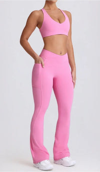 Person wearing a pink sports bra and leggings set on a white background